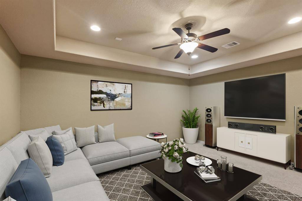 Virtually Staged: No need to go to the movie theater with this fantastic media room! It includes a tray ceiling with a ceiling fan, carpet floors, and recessed lighting.