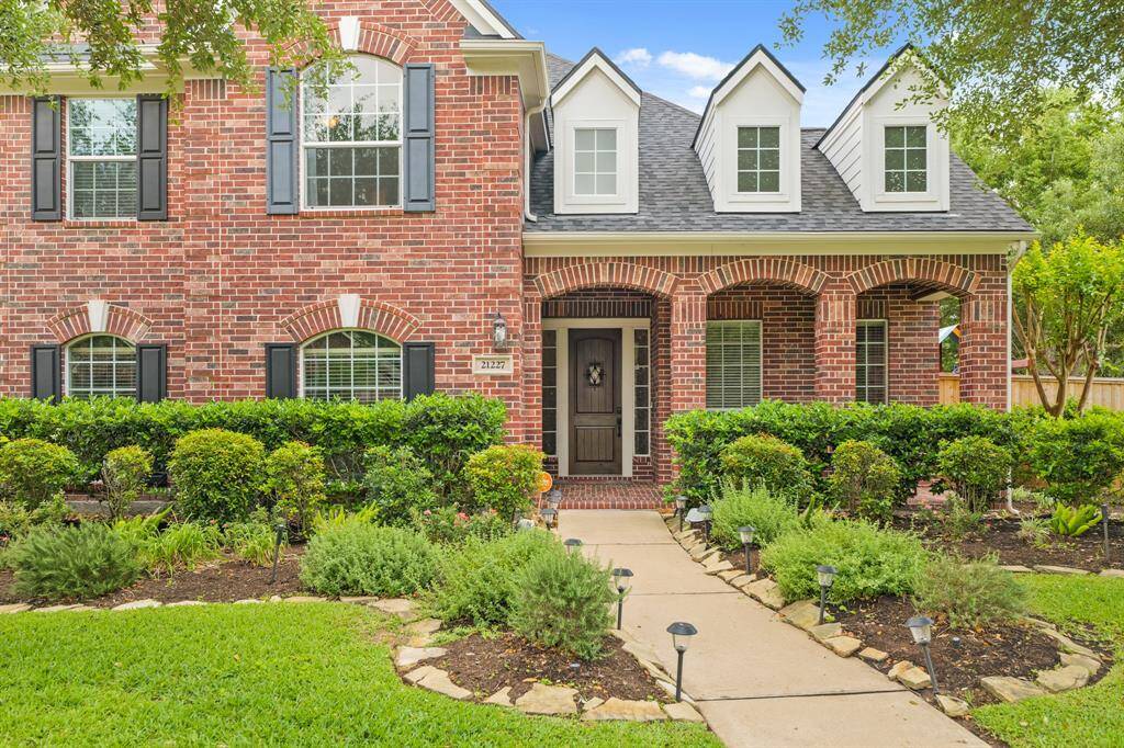 This captivating home boasts a grand curbside appeal.