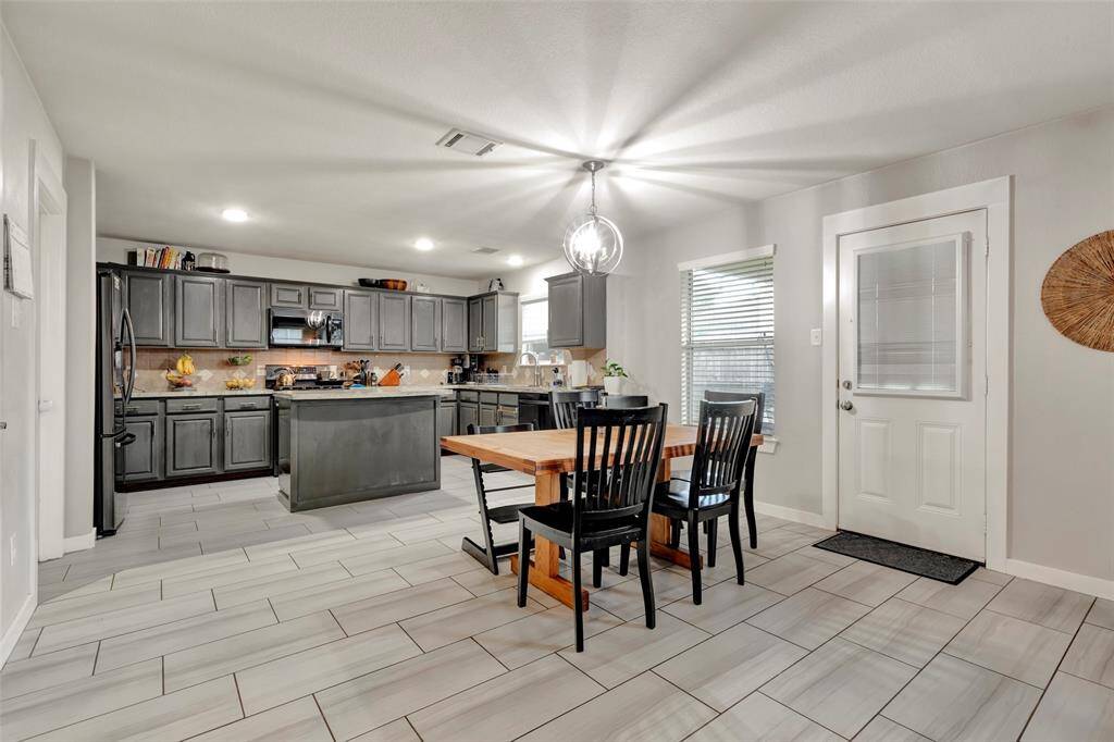 From a wider perspective, you can see the kitchen and dining area seamlessly connected in one open space.