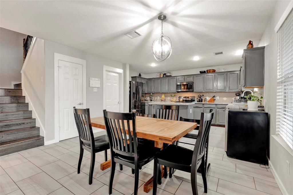 As you enter the home through the back door, the kitchen and dining area are to your right, with a staircase leading to the second floor adjacent to the dining area.