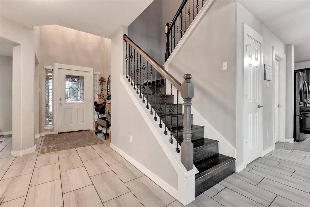 View of the formal entry of the house and the staircase leading to the second floor.