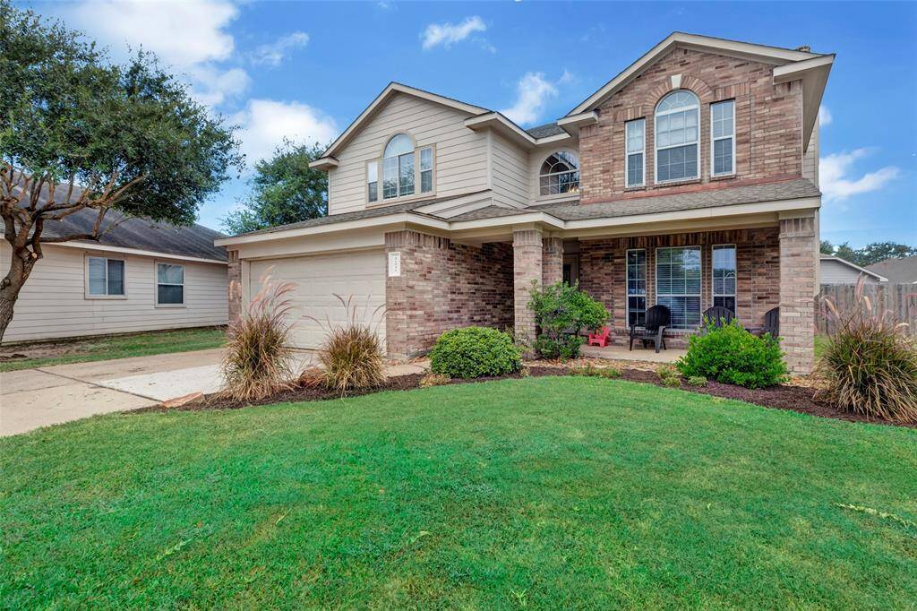 This home features a stunning brick & wood exterior.