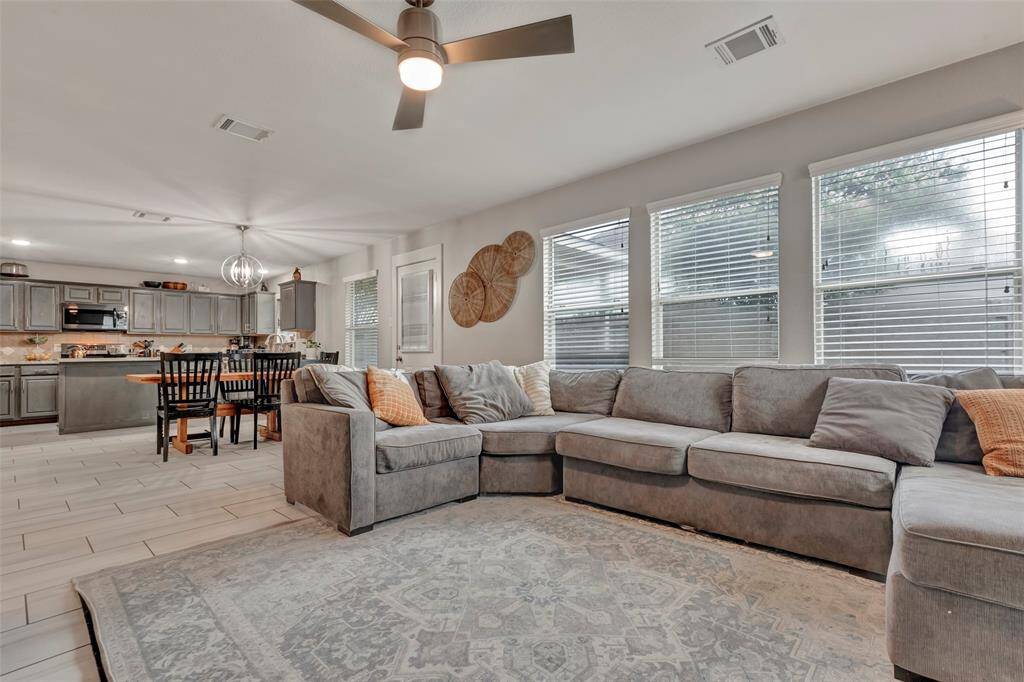 This home has an open-concept living room with a view of the kitchen and dining area, perfect for seamless entertaining.