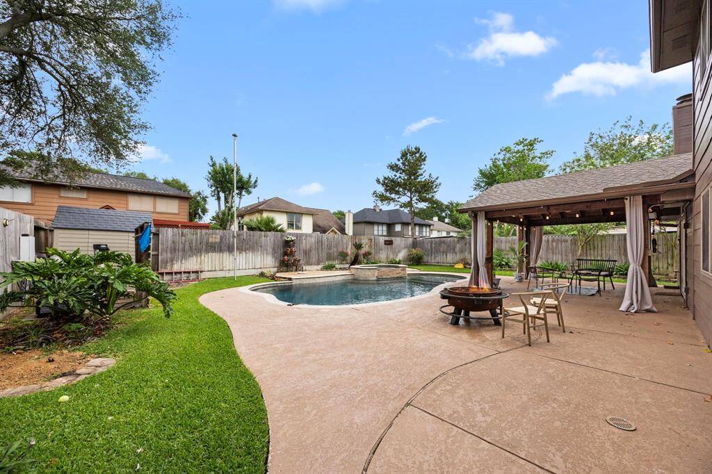 The backyard flatwork surrounding pool is ample offering multiple seating areas for lounging and entertaining.
