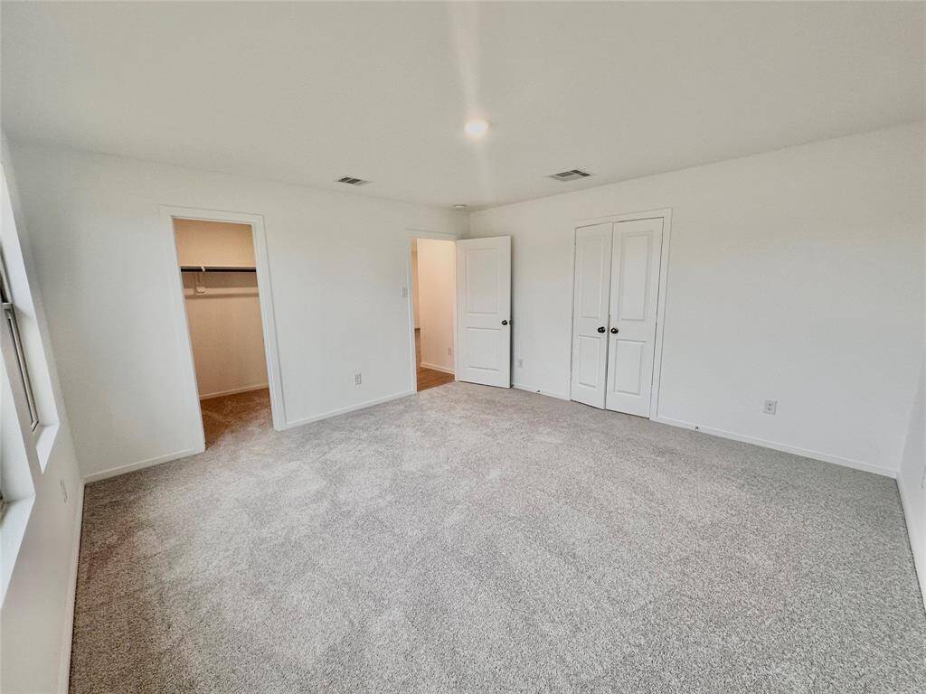 Another view of primary bedroom