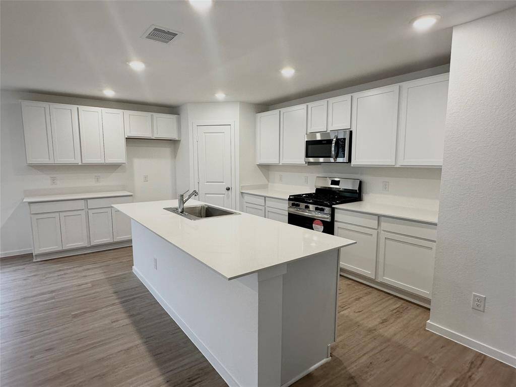 Large island and walls of cabinets