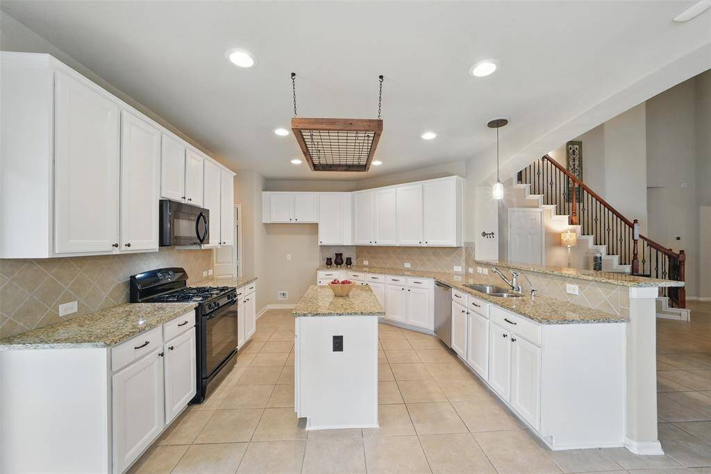 Lots of storage cabinets and counter space in this kitchen.