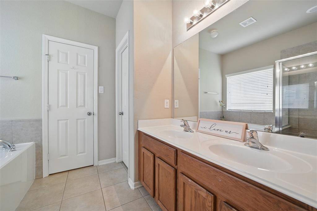 The primary bathroom features double vanities, a privacy door for the toilet and 2nd larger walk-in closet.