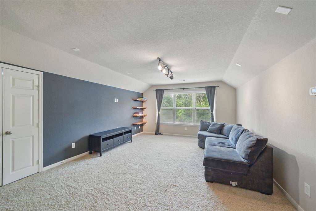 The sizable game room offers flexible living space for fun & games or a 2nd living room upstairs.