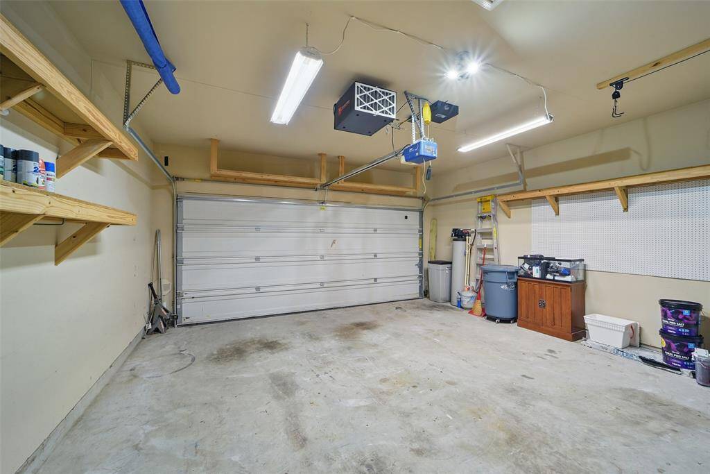 There are even storage racks above the garage door, peg boards for your tools, water softener and a garage door opener.