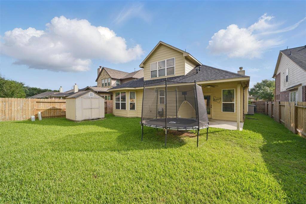 The backyard provides room to run and play.  It also comes with a storage shed and trampoline, if desired.