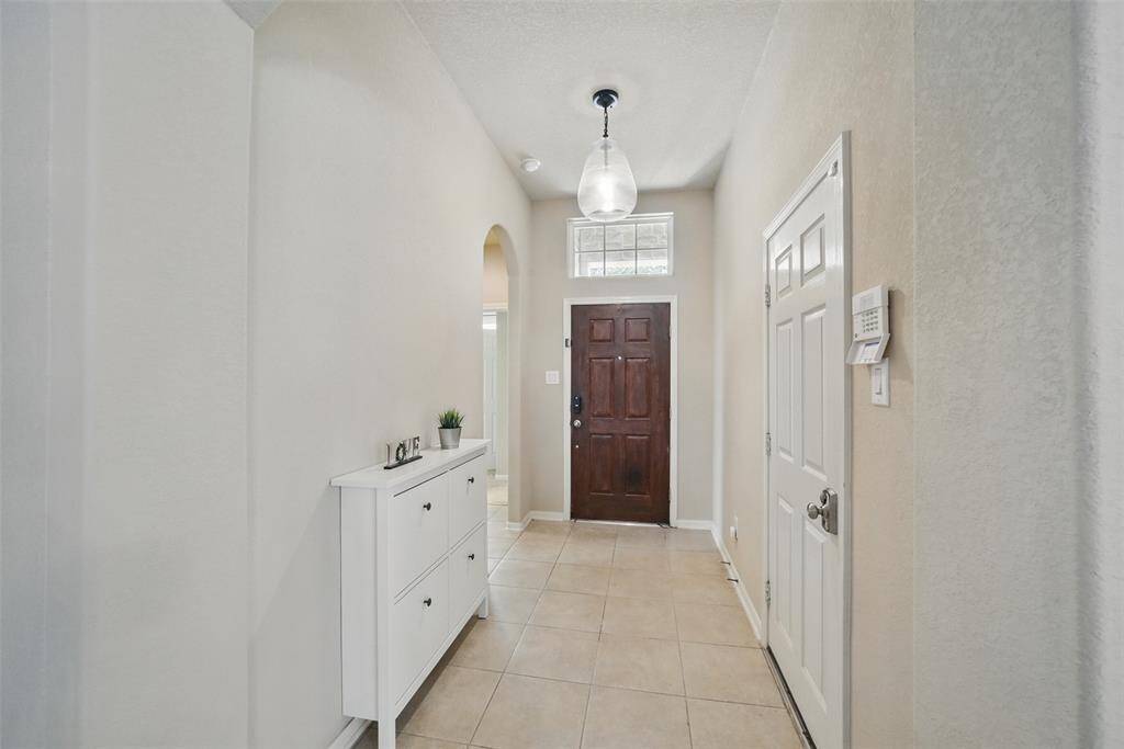 The entry hall adjoins the front door, hall to the guest rooms, guest bath and the garage.