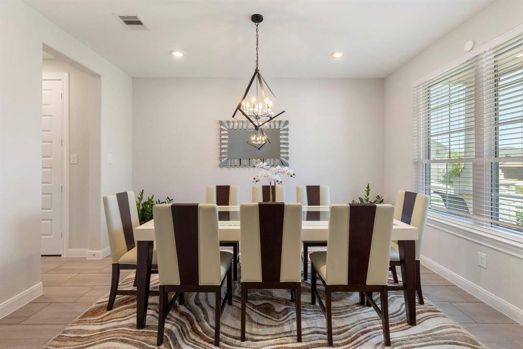 The formal dining room features custom lighting.