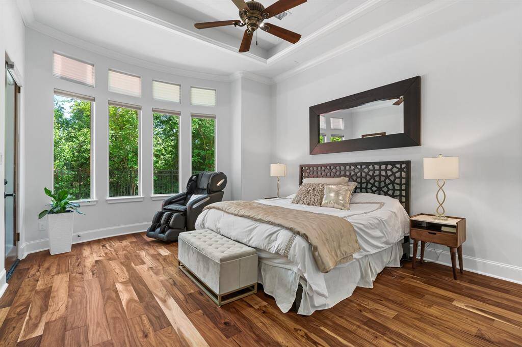 Along with private access to the patio, this spacious primary suite enjoys new Hardwood Acacia floors.