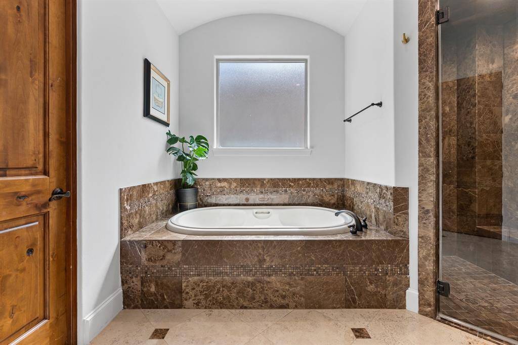 Additional features include a large soaker tub, walk-in shower and closet with updated hardwood acacia flooring.