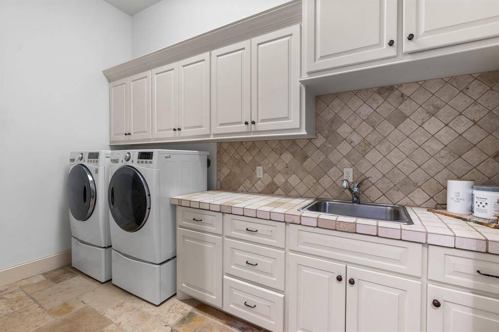 Full size utility is convenient to the garage entry providing plenty of storage and work space.
