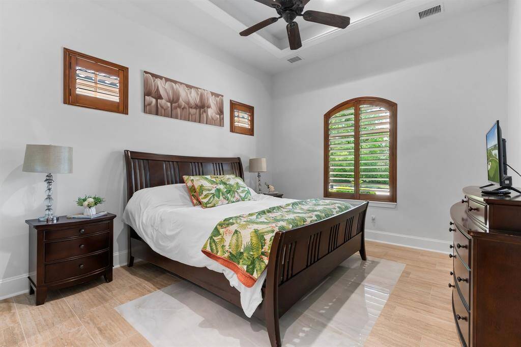 Everyone will love this spacious bedroom with a high, recessed ceiling, new flooring and serene view from the picture window.