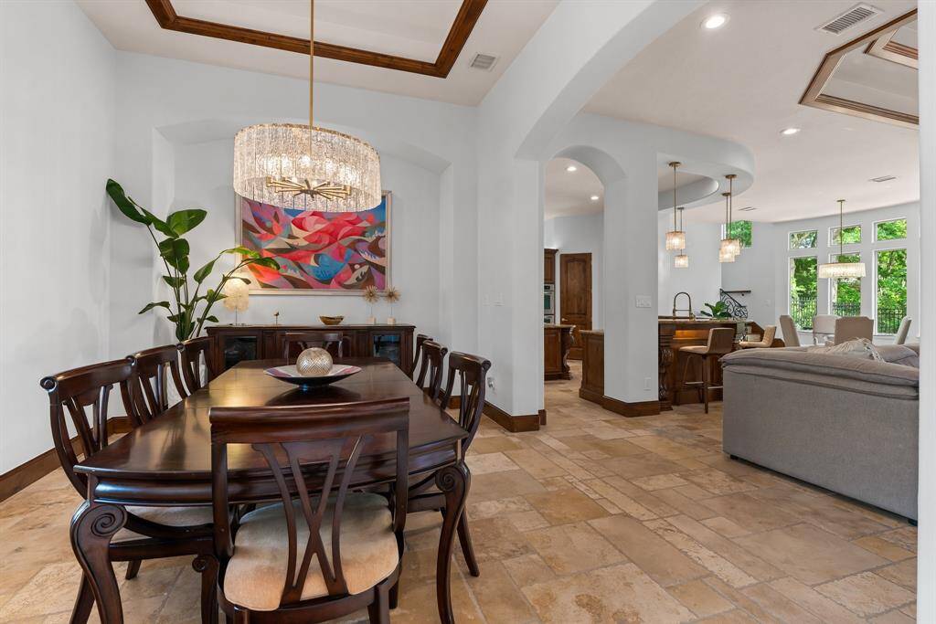The house features timeless travertine floors throughout the main living areas.
