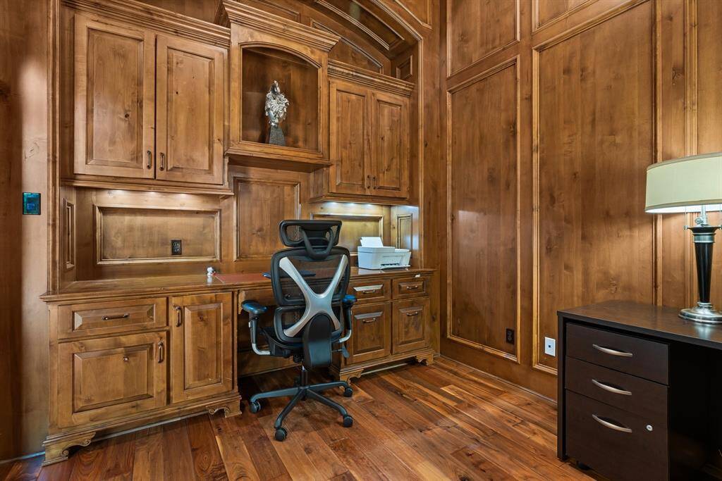 A handsome study showcases warm paneled knotty alder walls and built-ins.