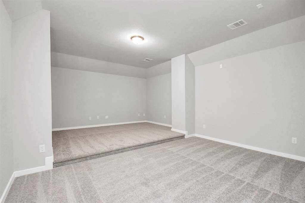 Experience entertainment at its finest in this media room – a standout feature in a home that has it all. Revel in the ultimate luxury with an elevated platform, setting the stage for an immersive cinematic experience or lively sports game nights. Sample photo of completed home with similar floor plan. Actual colors and selections may vary.