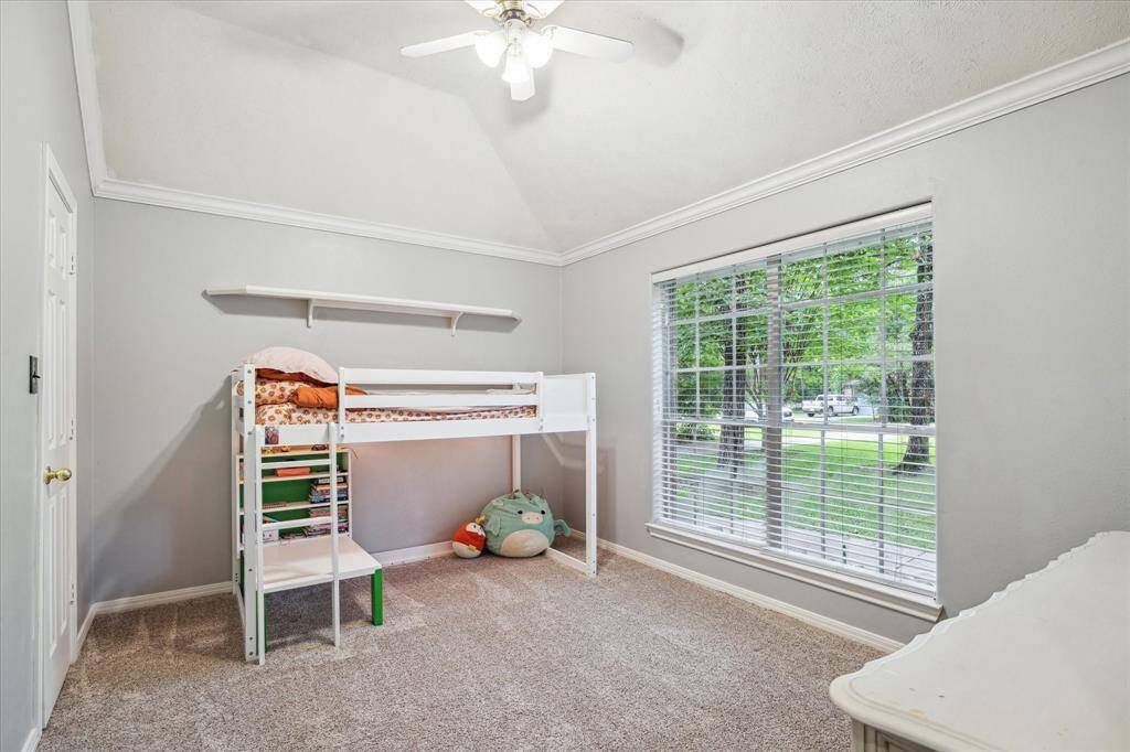 This secondary bedroom is thoughtfully positioned at the front of the home, offering privacy and plenty of natural light.