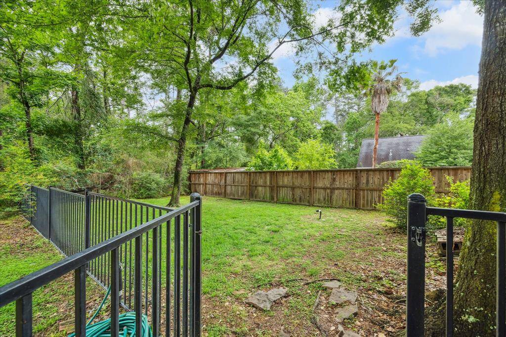 The gated side yard behind the 3-car garage offers a private, secure space that would be perfect as a dog run.