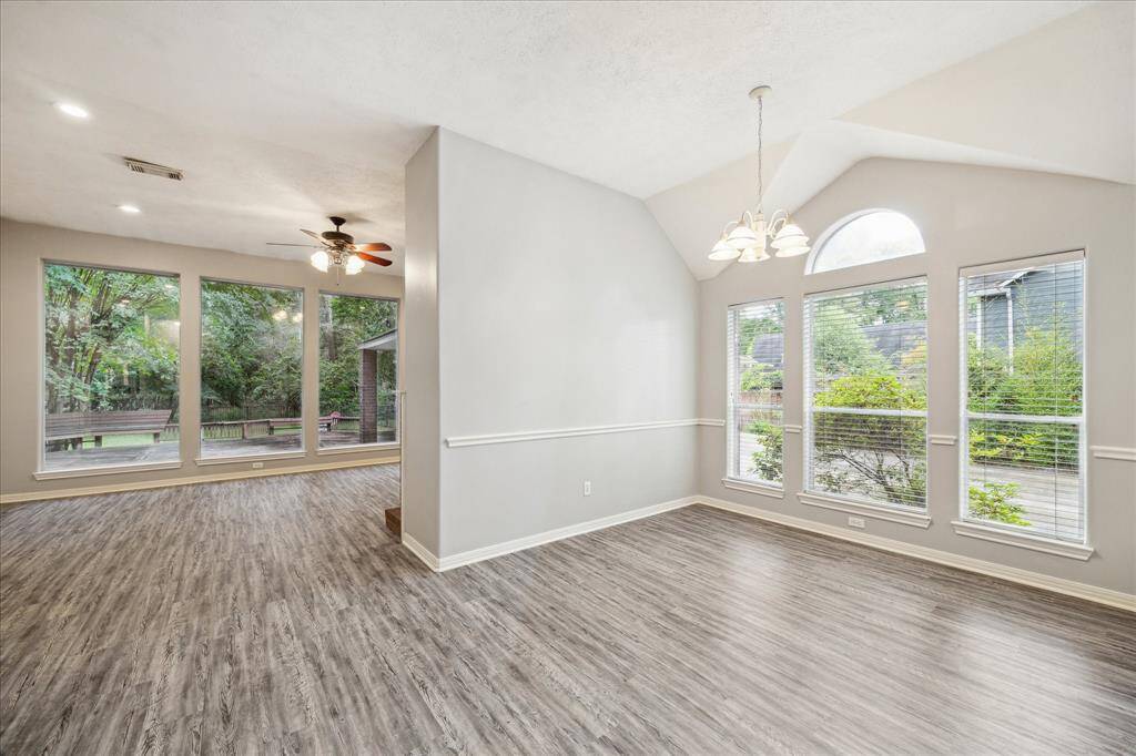 Abundant windows throughout the home provide beautiful views of the expansive lot. This photo showcases the cozy breakfast nook just off the kitchen.