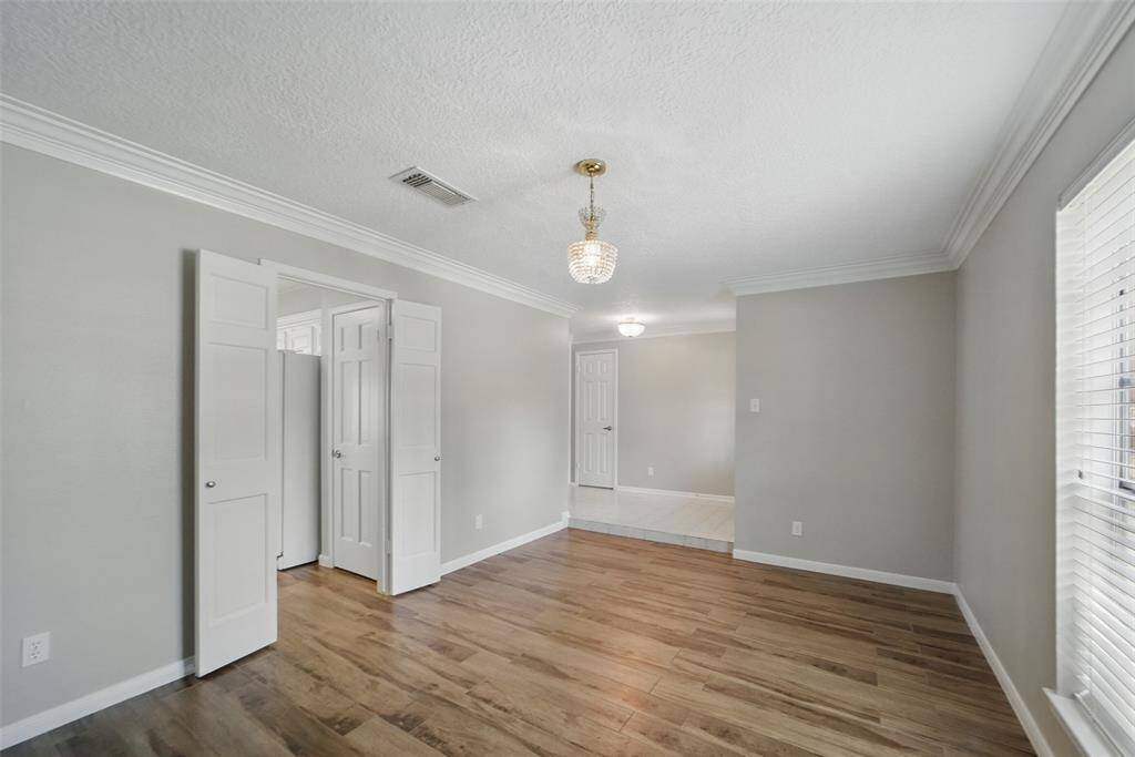 Beautiful crown molding, light fixtures and wainscoting in this dining room.