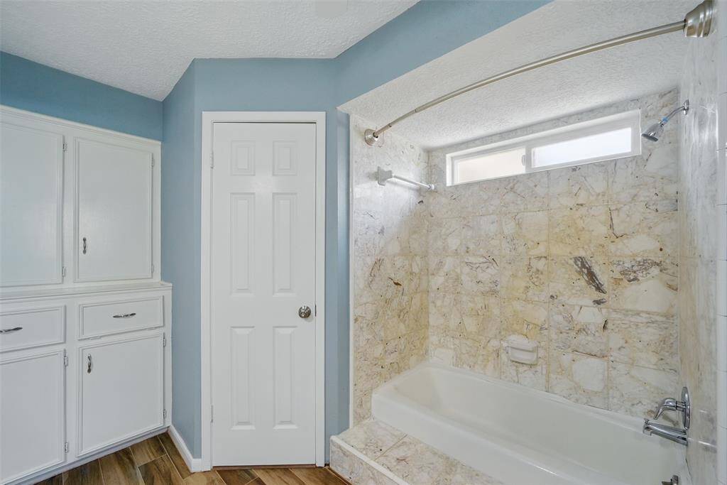 Custom Built-in with laundry hamper & Terrazzo tile shower.