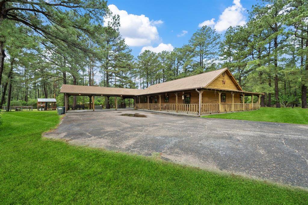 Beautiful log cabin with wrap around porch and 3 car carport