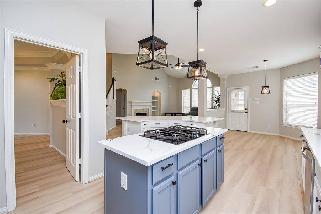 This photo showcases modern pendant lighting and sleek cabinetry, creating a welcoming atmosphere.