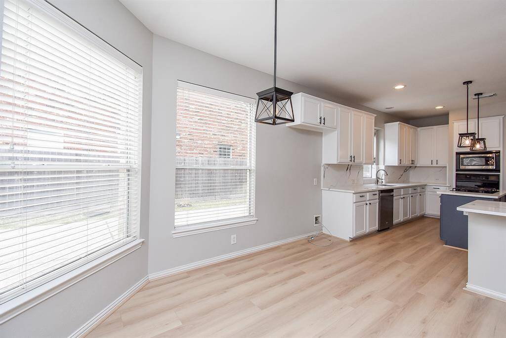Large windows offer natural light, and stylish pendant lighting adds an elegant touch.