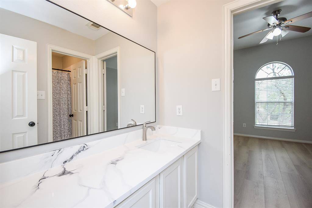 Adjacent to the bathroom is a glimpse of the secondary bedroom.