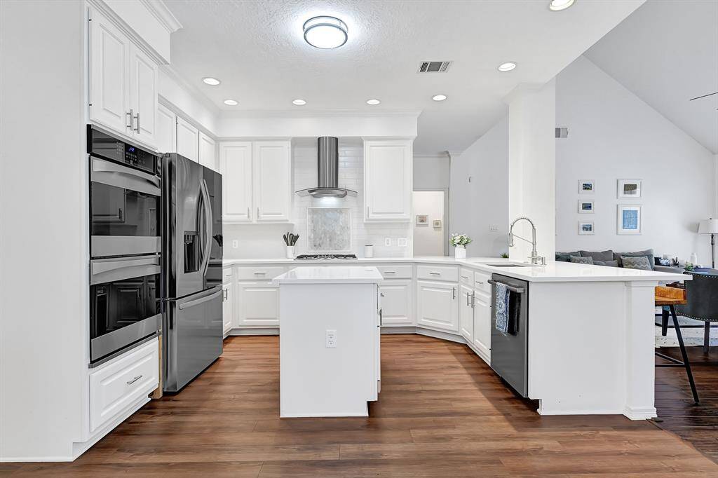 Bright and airy open-concept layout with a double oven, combining style and function for the home chef.