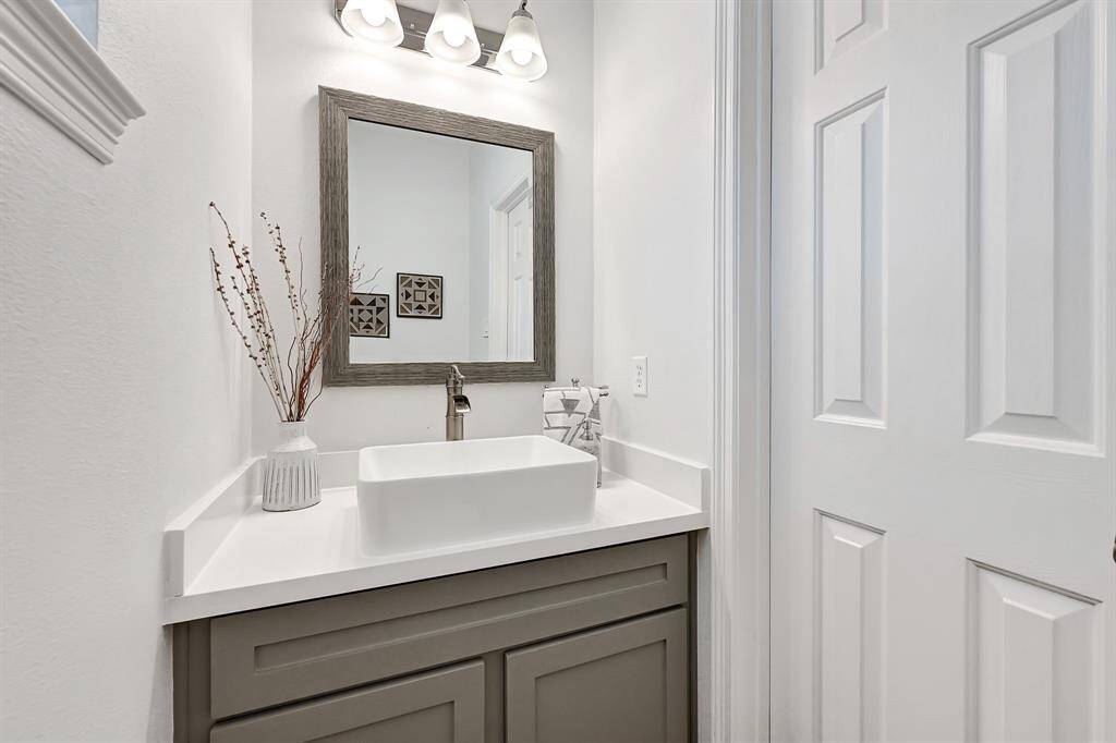 Convenient first-floor half bath with modern fixtures and a stylish touch