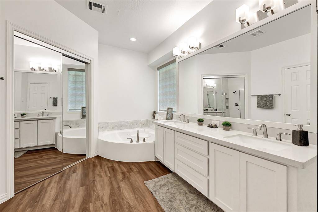Elegant en-suite bathroom featuring Silestone countertops and a relaxing Jacuzzi tub for a spa-like retreat