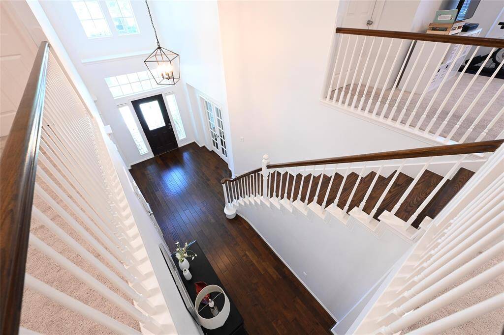 Stunning hardwood staircase, fully renovated in 2023, adds warmth and elegance to the home