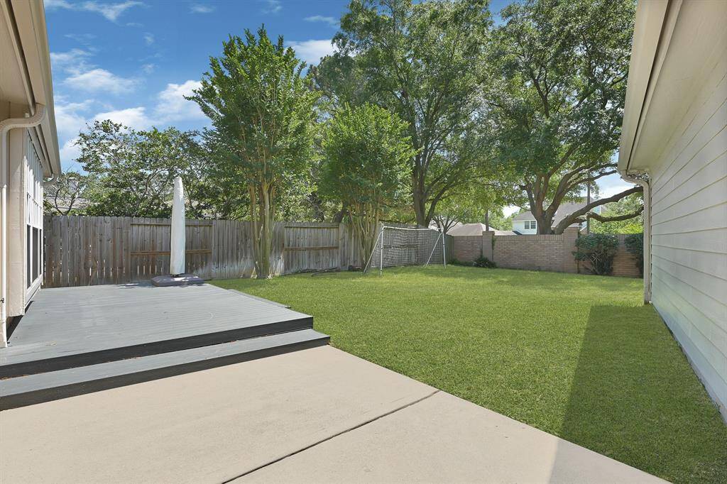 Expansive backyard featuring a low-maintenance composite deck, newly completed in 2023—perfect for outdoor entertaining