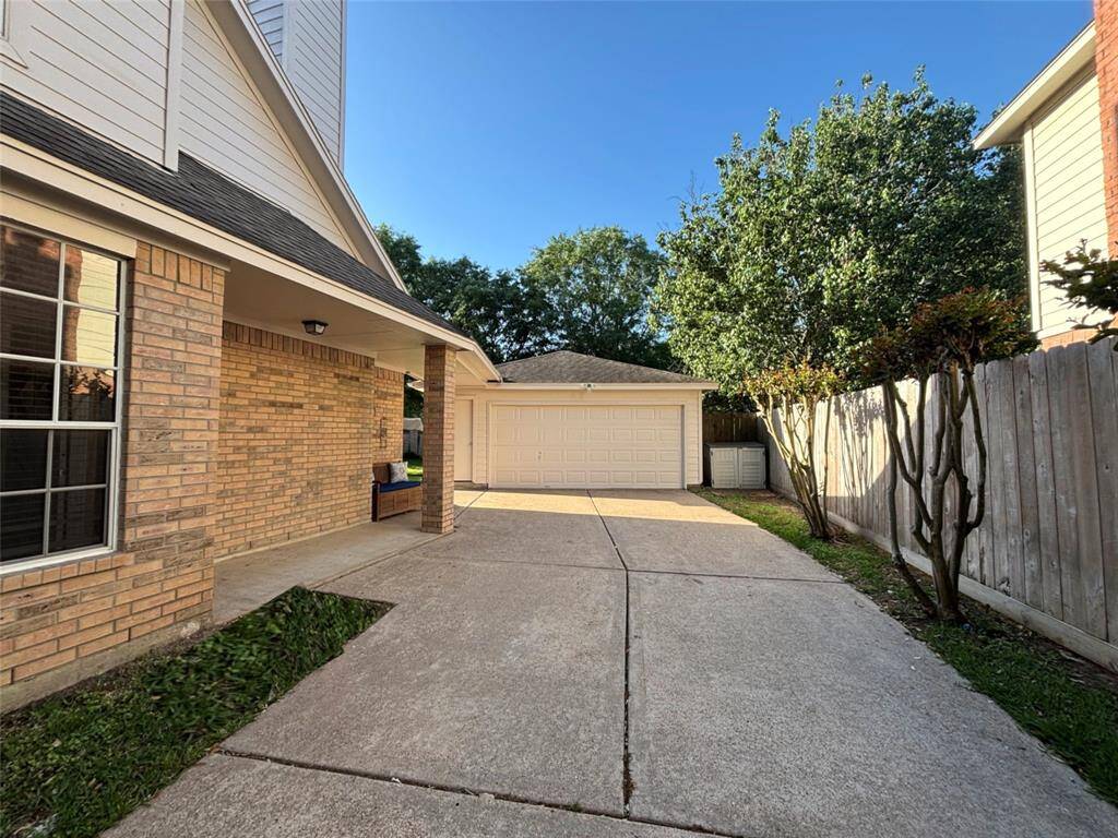 Extended gated driveway doubles as a versatile outdoor space, seamlessly connecting to the backyard.