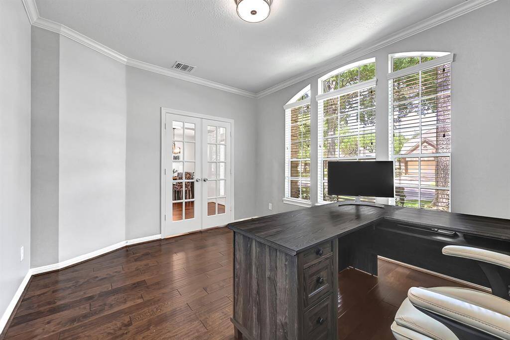 Secluded home office with large windows that flood the space with natural light
