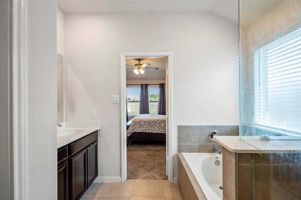 The primary bathroom has dual sinks, soaking tub, standalone shower and a generously sized closet.