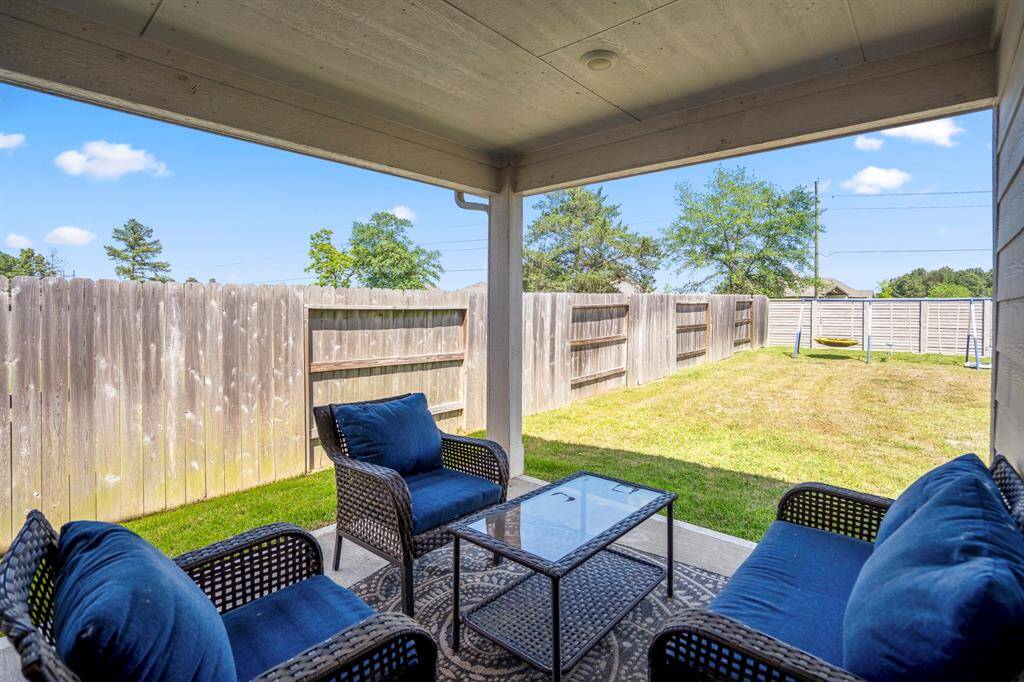 Enjoy spending time on your covered patio, overlooking your oversized lot.