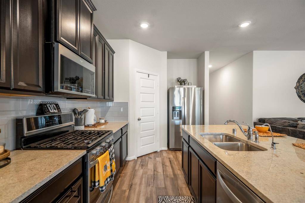 Your kitchen has been upgraded with granite counters, stainless steel appliances,a walk-in pantry, and open to the living areas.