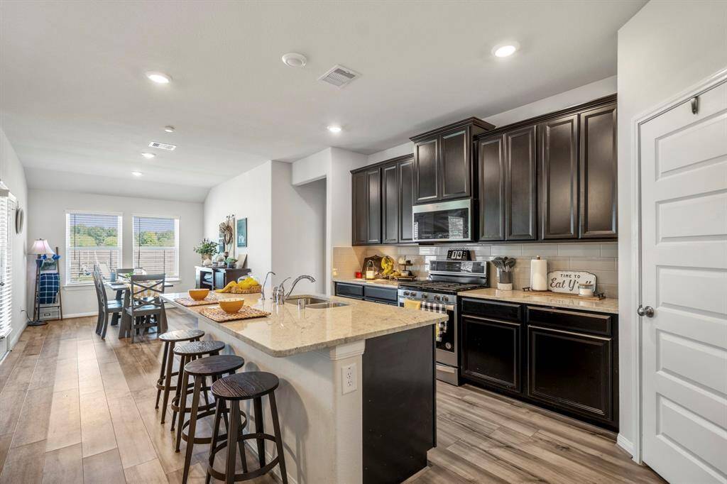 Your kitchen has been upgraded with granite counters, stainless steel appliances,a walk-in pantry, and open to the living areas.
