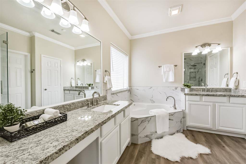 Primary bath with garden tub, granite counters with vanity area.