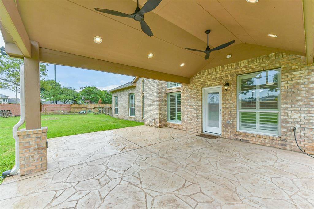 Extra large patio has stamped concrete, canned lighting and ceiling fans.