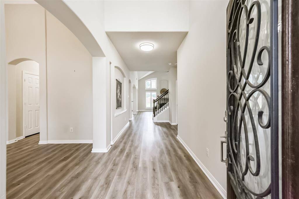 Welcome to 2401 Dry Bank Lane with custom decorative door with wrought iron. Grand two story entry. Easy maintenance Laminate plank flooring.