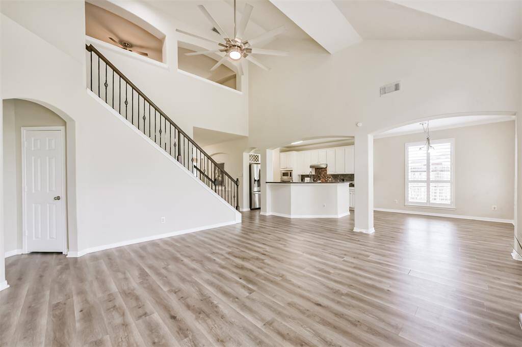 Spacious den it open to kitchen & breakfast.  Wrought iron spindles on stair case.