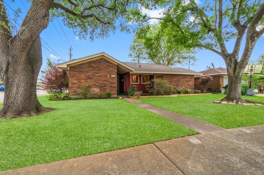 Welcome to 2401 Halkies Rd! Front elevation of home is framed with two mature trees.