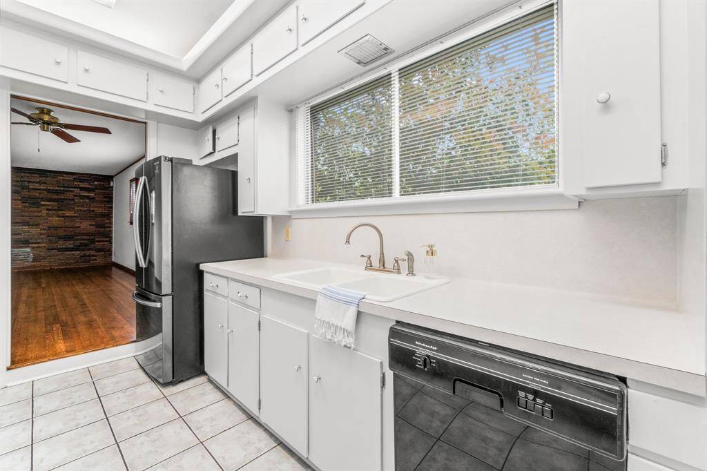 Another view of Kitchen with double porcelain sinks. Notice the cabinets above for extra storage! Refrigerator is included in the sale of this home.